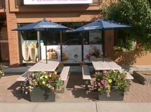 Store front , lots of parking out front , wide sidewalk